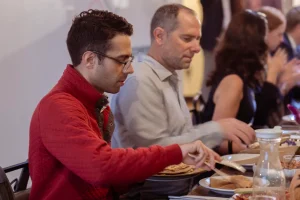 lose-up of guests using in-house glassware and plateware rentals during a catered corporate luncheon in Midtown Manhattan.