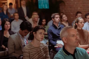 Guests seated in modern grey event chairs, highlighting professional in-house rental options for NYC corporate events