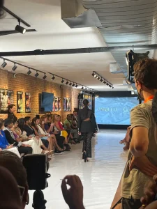 Rear view of a fashion model walking the runway during a designer apparel launch event in a Manhattan loft.