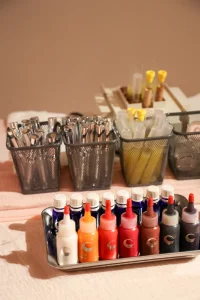 Vibrant pink "Spring Social" event signage on an easel with floral accents in a sunlit industrial loft.