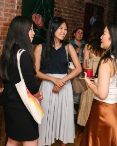 Chic event staging and custom furniture layouts for a corporate networking event in an industrial loft.