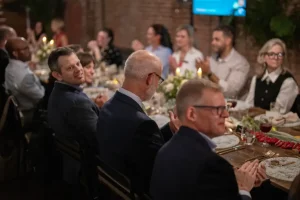 A group of VIP guests celebrating at a curated corporate dinner event.