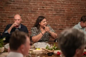 Corporate executives raising a toast during a high-stakes board dinner.