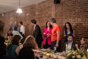 Professionals networking during a seated executive dinner in the LOFT39 dining loft.