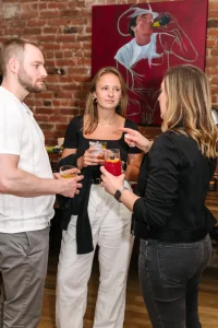 Handheld signature drinks being served at a branded corporate social in a luxury Midtown Manhattan venue.