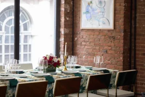 Lush floral arrangements spanning the length of a professional dining table.