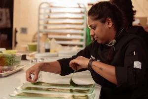 Detailed shot of a chef plating a sophisticated course, highlighting the culinary infrastructure available for events at LOFT39.