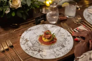 A close-up of a gourmet shrimp appetizer, part of a bespoke tasting menu.