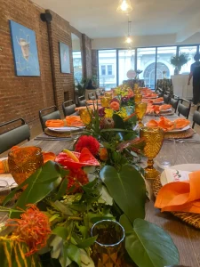 A massive floral installation serving as a centerpiece for an NYC loft dinner.