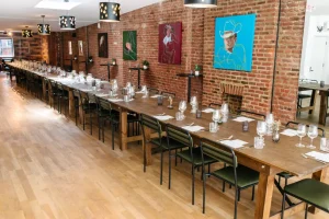 An expansive long-table arrangement for a 50-guest milestone celebration.
