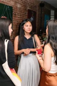 Professional catering staff serving passed appetizers during an industrial loft corporate cocktail party.