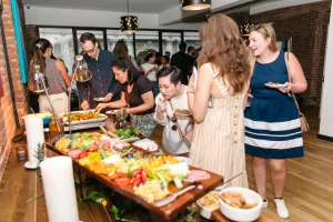 Professional mixologist serving wine and signature cocktails at a corporate open bar in a Midtown loft.