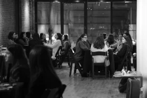 High-contrast photography showing the energy of an executive dinner party