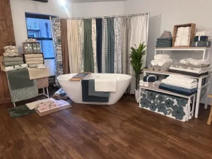 Full-wall retail display featuring a variety of home lifestyle products in an organized gallery layout.