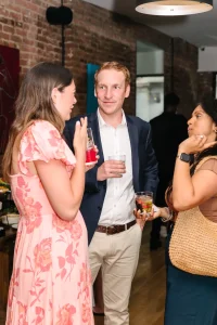 Professional business gathering and happy hour featuring exposed brick and modern event staging.