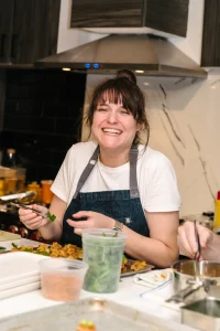 A private chef enjoying the professional kitchen environment during a culinary event.