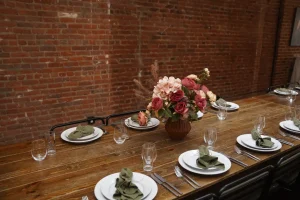 A bird's-eye view of a long dinner table with cohesive floral and candle design.