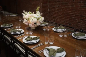 Detail shot of gold flatware and delicate floral accents on a designer dining table.