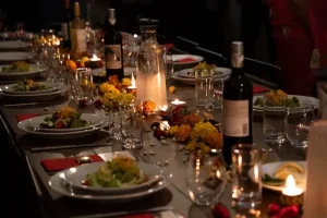 Vibrant floral centerpiece featuring red roses and orchids on a rooftop table with the Manhattan skyline in the background.