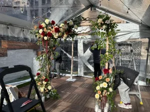 Warm sunset light hitting an outdoor wedding table setting on a luxury Manhattan rooftop terrace.