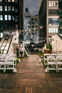 A fully set long table in a private dining room with exposed brick walls for an intimate wedding celebration.