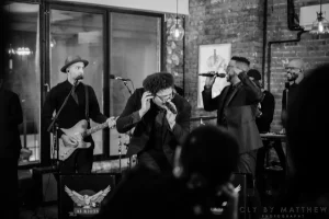 Classic black and white lifestyle photograph of a live jazz band performing on the hardwood floors of a historic Midtown Manhattan loft venue.