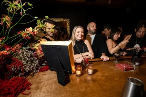 Skilled mixologist pouring a vibrant seasonal drink at a boutique holiday event space near Bryant Park.