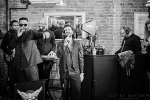 Monochromatic image showcasing custom cocktail staging and band equipment perfectly arranged for a sophisticated private music showcase.