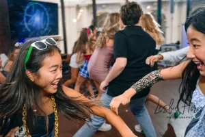 Event MC hosting an interactive dance game with kids at a non-religious Bar Mitzvah party in Midtown Manhattan.