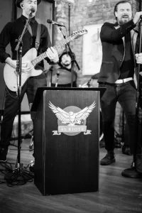 Sophisticated black and white event photography of live musicians providing ambient background music during an upscale cocktail hour.