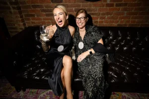 Intimate speakeasy nook hosting a fortune teller and tarot card reading activation for a company winter even