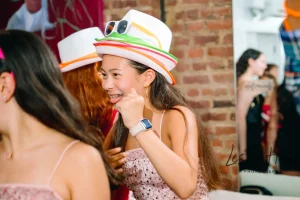Group of teenagers hanging out and laughing in a custom-designed youth lounge area at an NYC Bat Mitzvah venue.