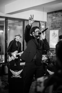 Artistic black and white abstract capture of guests dancing and celebrating a milestone birthday to a dynamic DJ set.