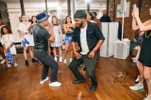 Candid photo of kids having fun and posing for pictures at a trendy warehouse-style milestone party.