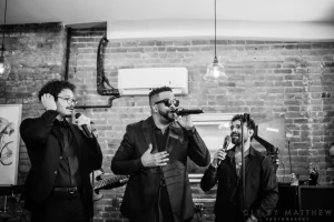 Editorial black and white image of a high-energy dance party hosted in an exclusive, private multi-level venue space.