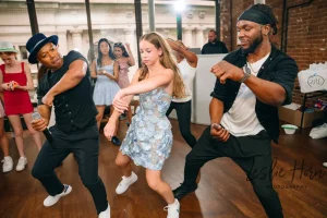 High-angle shot of young guests enjoying the energetic atmosphere at a boutique loft event space in New York.