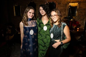 Guests showcasing elegant cocktail dresses and sharp suits at a private corporate holiday soirée.