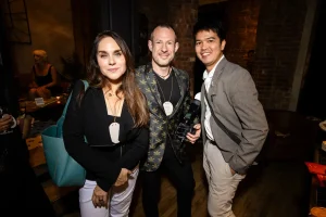 Warm and inviting wide shot of well-dressed professionals celebrating the festive season at LOFT39.