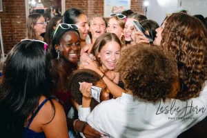 Vibrant wide shot of an entire loft floor filled with guests celebrating a girls modern Bat Mitzvah party in New York City.